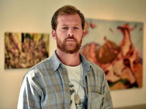 Artist Jacob Cullers stands in the gallery at Three Rivers Community College where his work is on display in a show titled “Castles Made of Sand.” Cullers’ brother, U.S. Army Staff Sgt. Ari Cullers, was killed by enemy fire in Afghanistan in October of 2011. (Sean D. Elliot/The Day) 