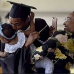 Keynote Speaker Knowles kisses his granddaughter