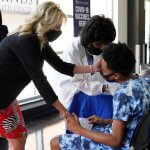 first lady jill biden comforting teen getting the covid 19 vaccination shot