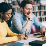 Female and Male Students studying together in the library